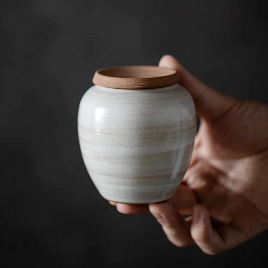 top view of the brown lid on the white ceramic tea storage canister