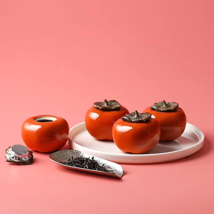 top angle view of decorative persimmon ceramic tea storage canister
