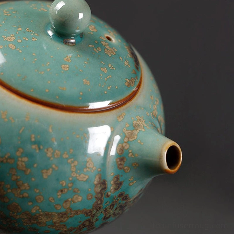 top view of rounded lid and knob of the green ceramic teapot