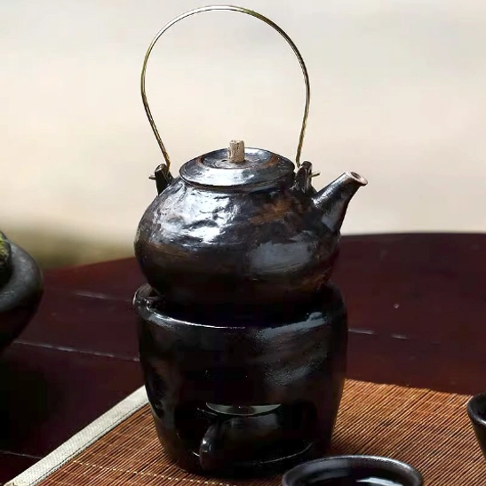 Top view of the ceramic teapot showing built-in infuser filter holes