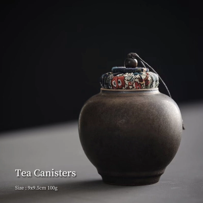 traditional Chinese tea canister next to other tea accessories