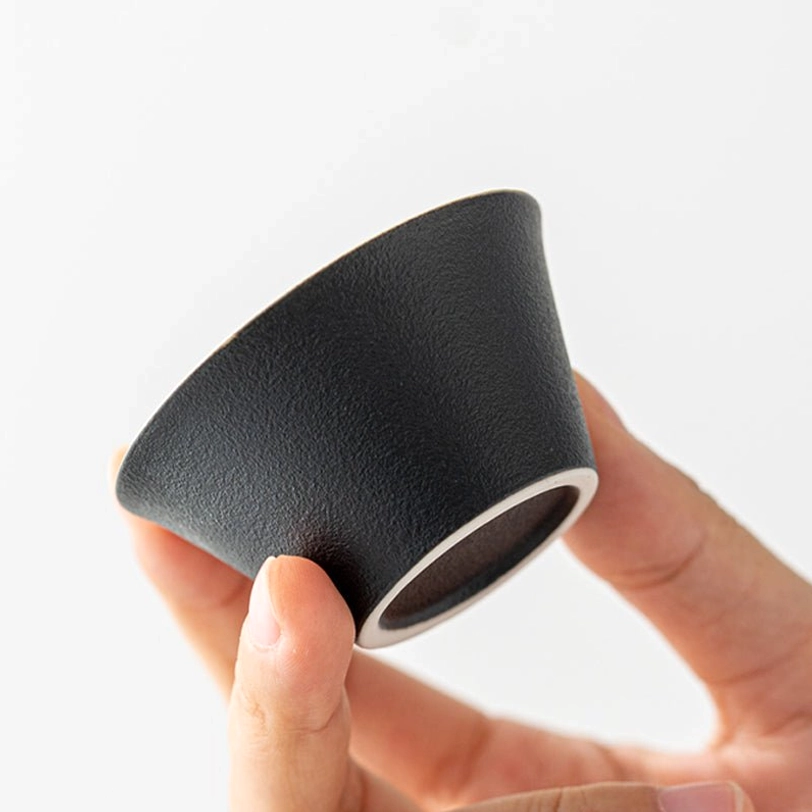 portable travel tea set held in hand to show compact size