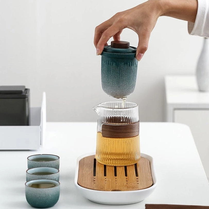 side view of full travel tea set showing teapot and three teacups