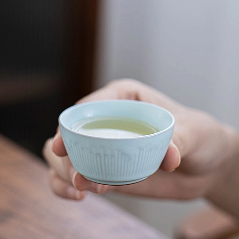 Clear glass tea pitcher holding brewed tea for travel tea set