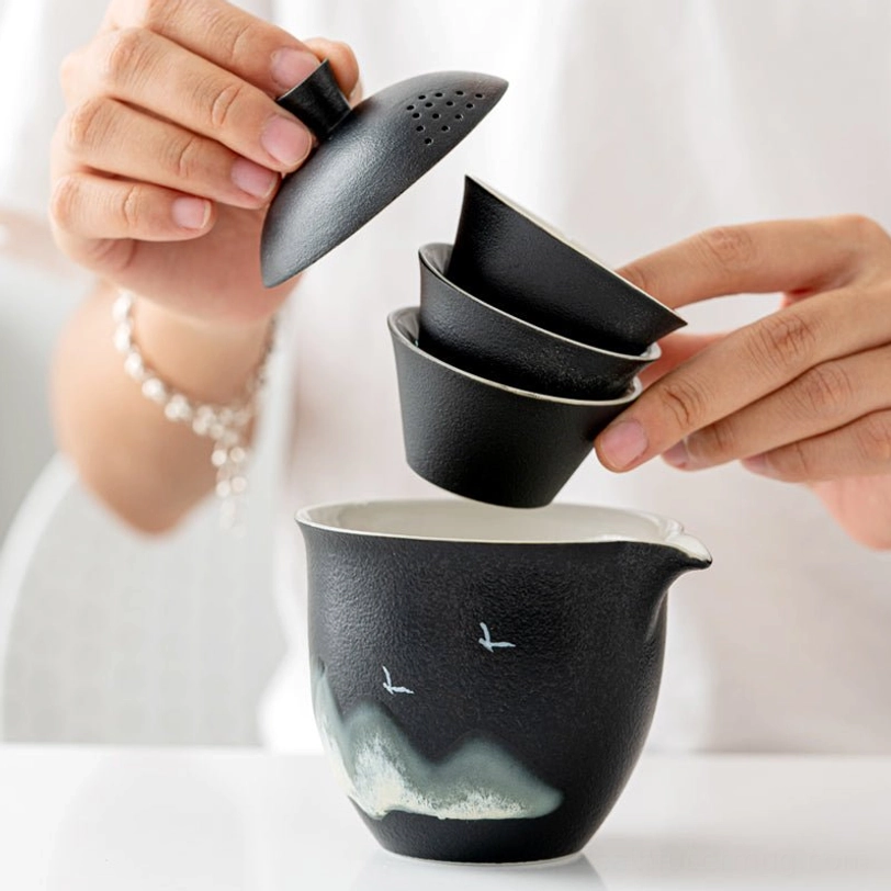 nested design of travel tea set showing three teacups fitting inside teapot