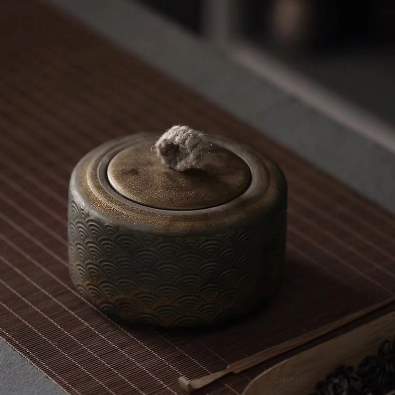 close up of embossed wave pattern texture on vintage tea canister