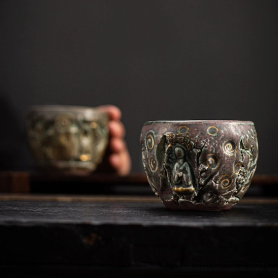 Vintage Chinese Buddha tea cup standing on wood tea table