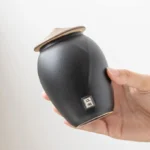 vintage ceramic tea storage canister with lid open showing tea leaves