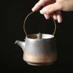 full view of 210ml vintage chinese ceramic teapot with infuser and golden metal handle