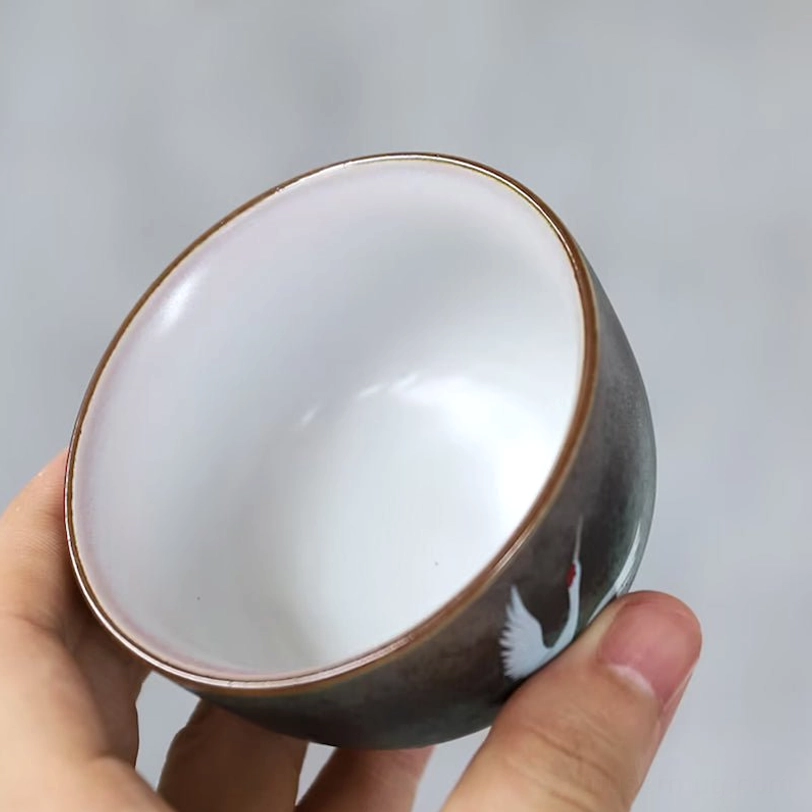 detailed hand drawn red crowned crane motif on chinese tea cup