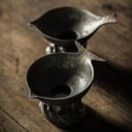 vintage metal fish tea strainer displayed with full tea set