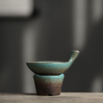 Full product view of vintage green gradient ceramic tea strainer with stainless steel mesh