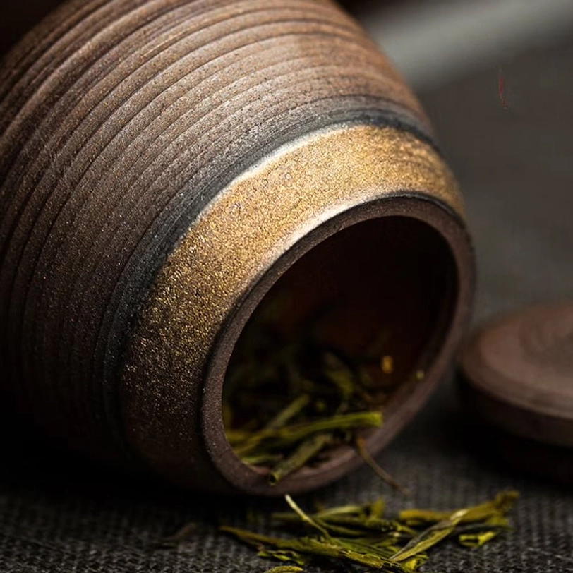 close up of spiral texture on vintage ceramic tea canister lid