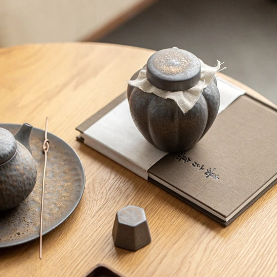 Rustic wabi-sabi ceramic tea storage canister as tea table decor