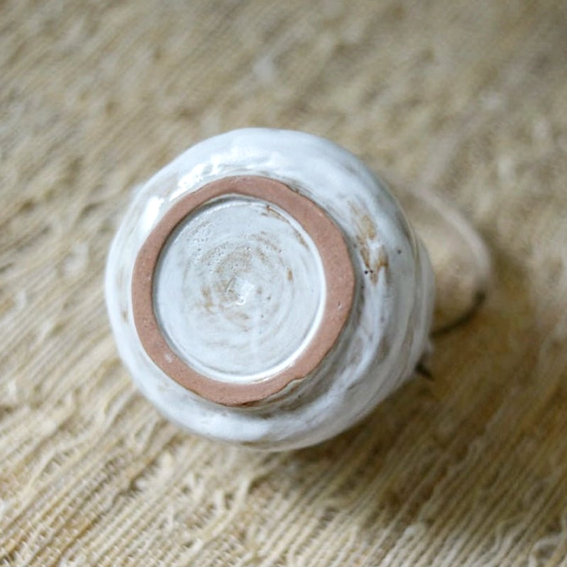 Bottom view of wabi-sabi ceramic teapot showing raw ceramic base