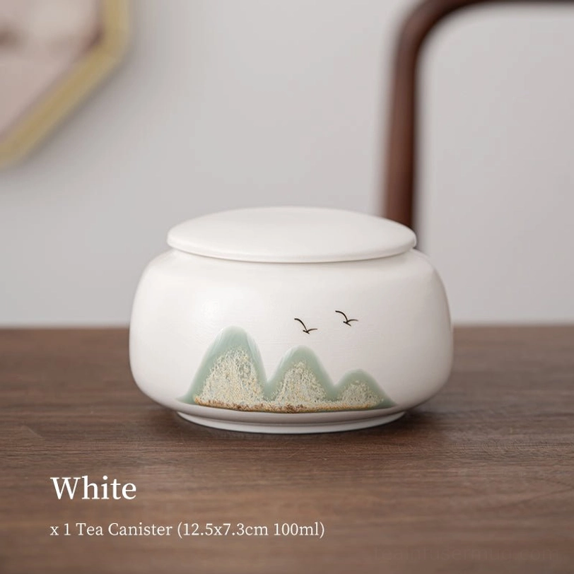white ceramic tea storage canister with landscape and bird pattern