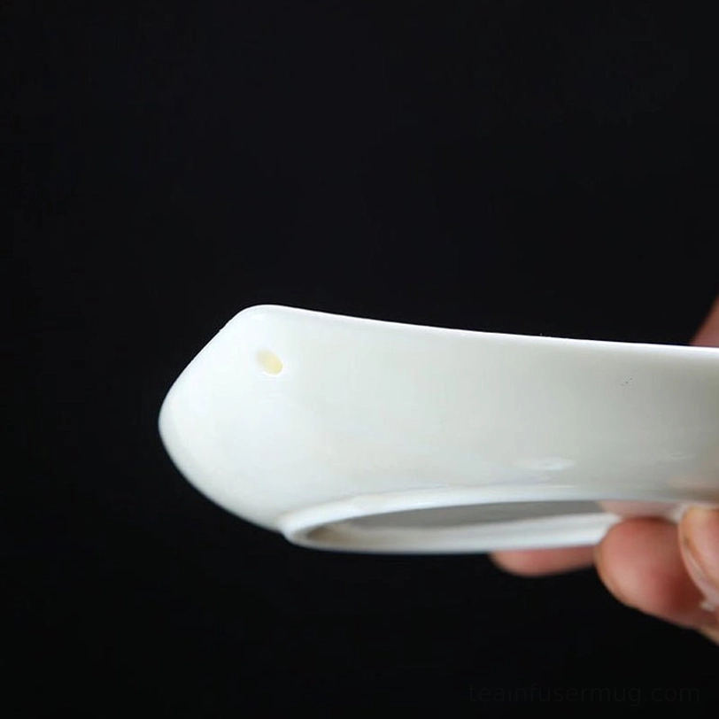 close up of mountain shaped knob on white porcelain gaiwan lid