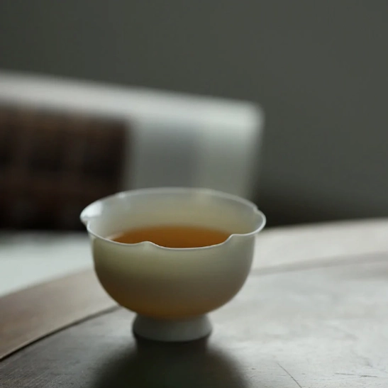 interior view of white lotus petal rim mini porcelain tea cup