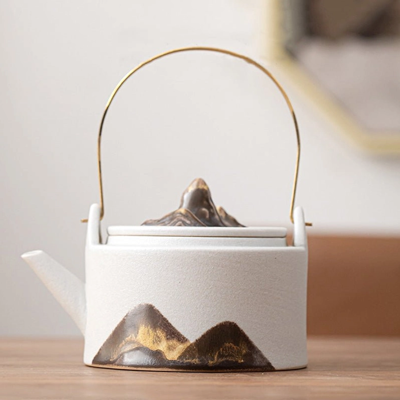 white mountain pattern ceramic teapot with brass infuser handle