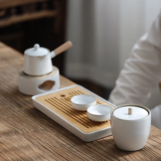 close up of natural wood handle on ceramic tea storage jar
