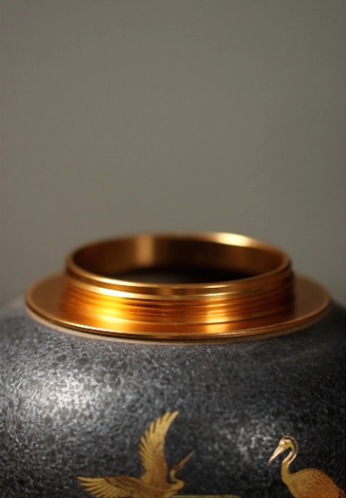 Top down view of wooden lid with golden cloud pattern for tea storage canister