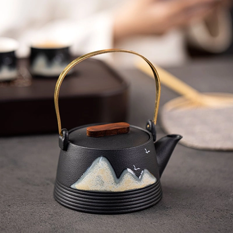 wooden lid knob detail on black ceramic mountain teapot
