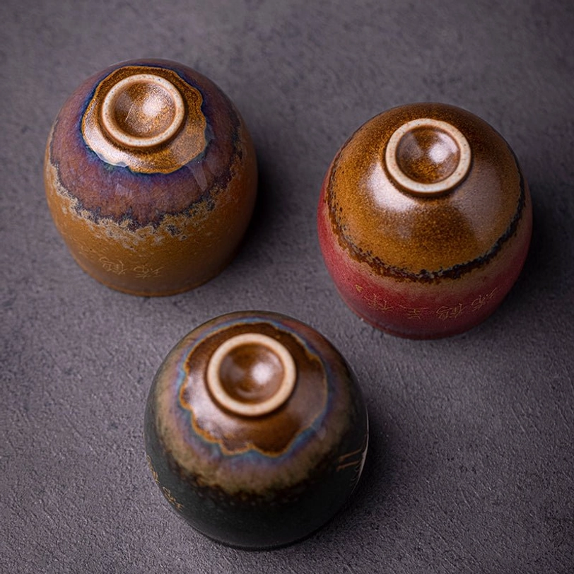 hand holding yellow vintage chinese ceramic crane tea cup